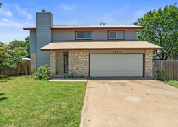 Two-story Round Rock home exterior with stone accents and driveway