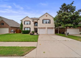 Two-story Cedar Park home with brick exterior and manicured lawn