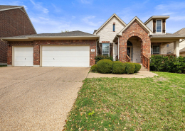 Cedar Park home exterior with brick facade and three-car garage