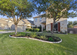 Two-story Cedar Park home exterior with landscaped front yard