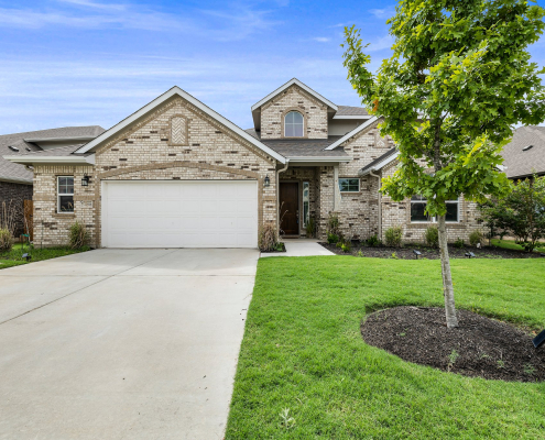 Single-family home exterior with driveway and three-car garage