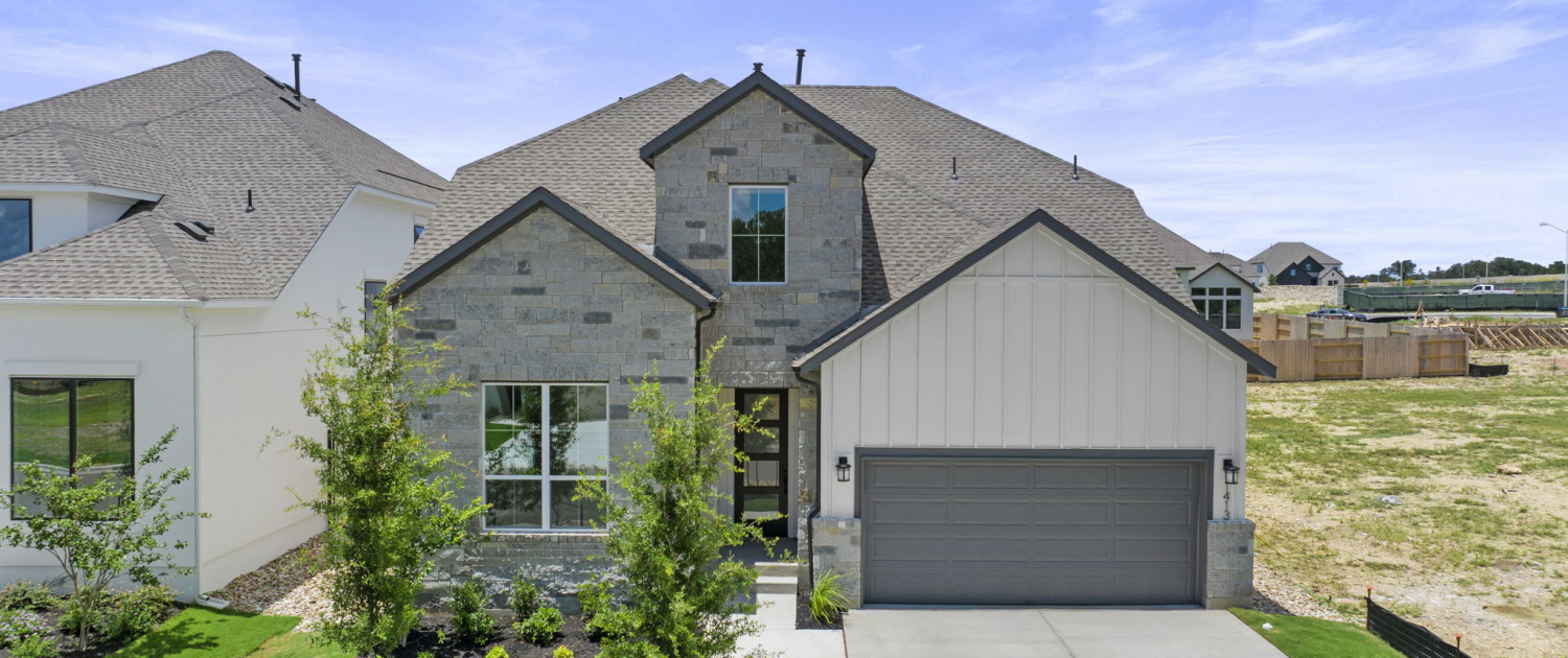 Toll Brothers Leander home exterior with stone facade, capturing by bokomedia